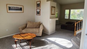 A living room with a beige sofa, a wooden coffee table, and framed pictures on the wall. - 4 Bedroom Mountain Retreat - Garden of the Gods (Colorado Springs)