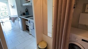 A compact kitchen with a sink, a microwave, and a small countertop. - Sea view, beach and port 2m away on foot, private parking  (Agde)