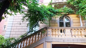 A building with a balcony, a window, and a staircase. - Tilia (Bologna)