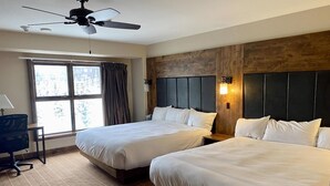 A hotel room with two beds, a desk, and a ceiling fan. - Peaks Penthouse #643 (Mountain Village)