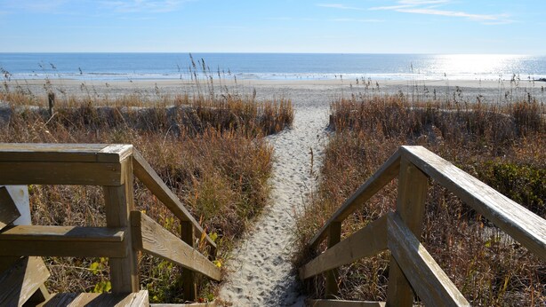 A wooden boardwalk leading to a beach with a clear view of the ocean. - Sea Cloisters I 101B - Oceanfront Condominium in Surfside Beach (Surfside Beach)