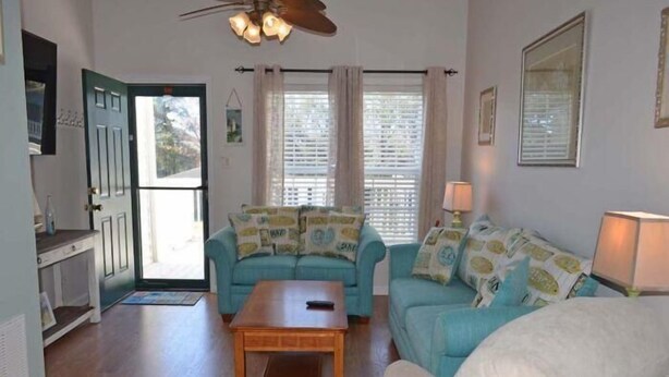 A living room with a sofa set, a coffee table, and a ceiling fan. - Tucked Inn 2.0 - Walk to Beach Triplex in Surfside Beach (Surfside Beach)