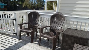 A wooden deck with two brown chairs and a small table. - Tucked Inn 2.0 - Walk to Beach Triplex in Surfside Beach (Surfside Beach)