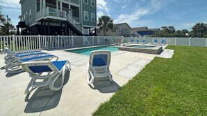 A two-story house with a swimming pool and lounge chairs. - Buckeye Heaven - Second Row in Garden City Beach (Garden City Beach)
