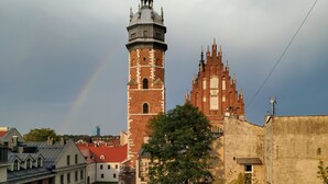 A historic church with a prominent tower and a large, ornate building with a spire. - Dada Premium Aparthotel (Kraków)