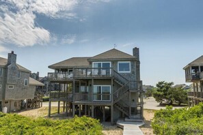 A two-story beachfront house with a balcony, a covered porch, and a deck. - Oceanfront Discounted October! (Duck)