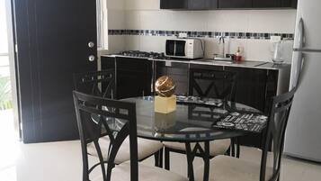 Full-sized fridge, microwave, stovetop, cookware/dishes/utensils