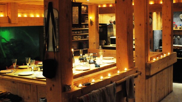 A wooden interior with a bar area, wooden beams, and a mirror reflecting the room. - Réserve Naturelle de Boussière (Gigors-et-Lozeron)