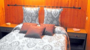A bedroom with a bed, two nightstands, and a headboard. - Charming T3 "Les Cerdans" 4 seasons 2 people (Porté Puymorens)