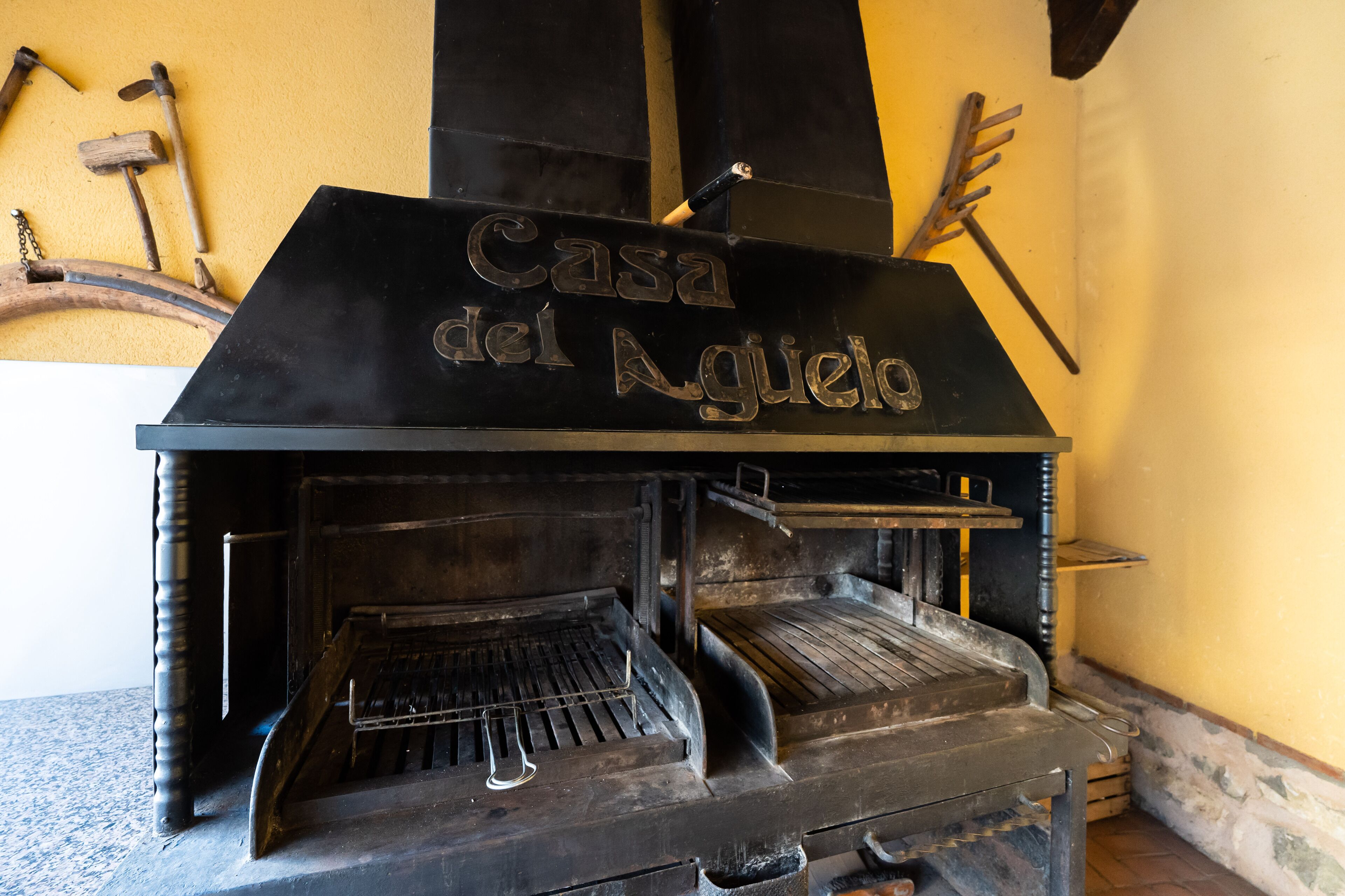 A traditional stone oven with a sign reading "Casa del Aguilo".