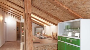 A kitchen with a stone backsplash, wooden beams, and a green cabinet with glass doors. - Tre Rose by Interhome (Opatija/Zvoneće)