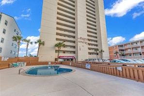 A hotel with a swimming pool, palm trees, and a parking lot. - Atalaya Towers 303 - Oceanfront in Garden City Beach (Garden City)