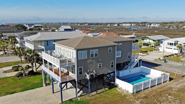 A multi-story residential building with a balcony, a pool, and a view of the surrounding landscape. - Lefty's LegaSea - Walk to Beach in Garden City Beach (Garden City Beach)