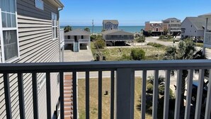 A residential area with houses, a beach, and a clear sky. - Lefty's LegaSea - Walk to Beach in Garden City Beach (Garden City Beach)