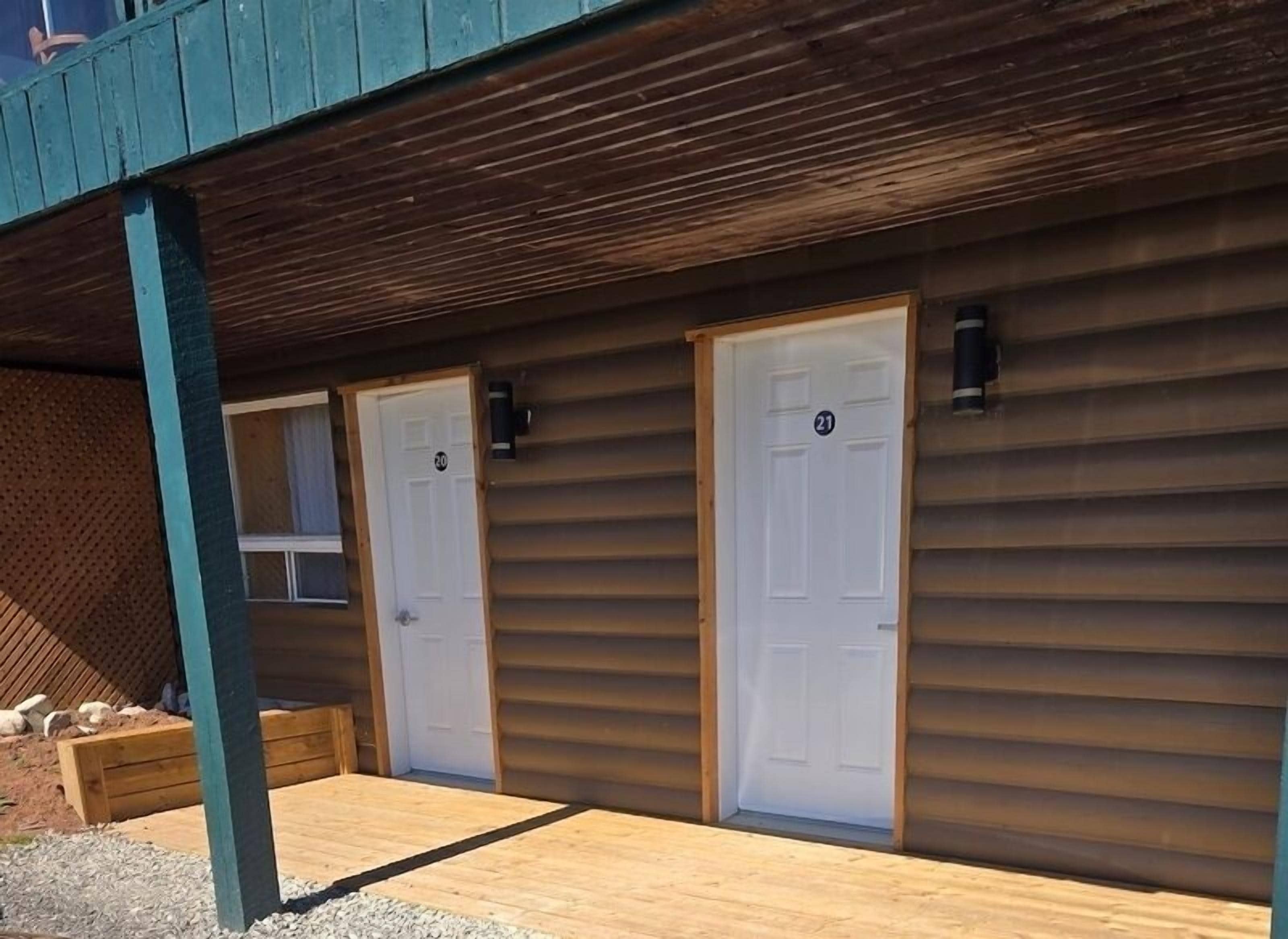 A building with two white doors, each marked with a number.