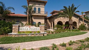 A sign for Bella Piazza with a stone facade and arched windows. - Bella Piazza 288924 (Davenport)