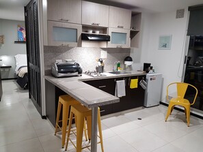 Fridge, oven, coffee/tea maker, cookware/dishes/utensils