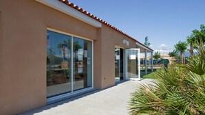 A modern building with large glass doors and a covered outdoor area.