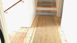 A wooden staircase with a handrail and a textured mat at the bottom. - Great location, close to Ventnor beach and town. Perfect for families. (Isle of Wight)
