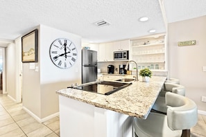 Enjoy cooking in this kitchen with a stovetop, refrigerator, and microwave.