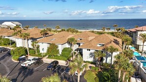 Residents enjoy ocean views from their homes with terracotta roofs and white walls.