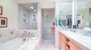 A modern bathroom with a large bathtub, a separate shower area, and a vanity with a mirror. - Penthouse At The Peaks 746 (Mountain Village)