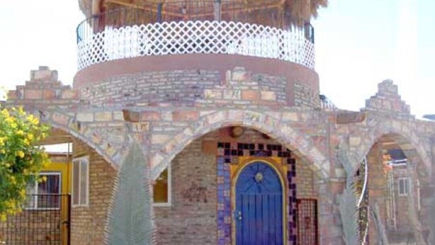 A building with a thatched roof, a blue door, and stone arches. - Friendly and safe beach Home La Casita (San Filipe)