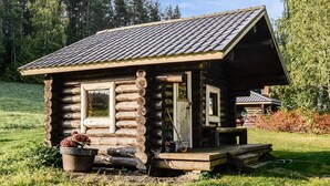 A log cabin with a porch, a small window, and a door. - Savilahti by Interhome (Juuka)
