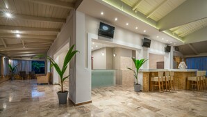A spacious lobby with a reception desk, seating area, and potted plants. - Hotel Zakynthos  (Zakynthos)