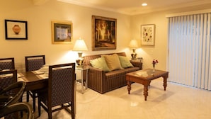 A living room with a dining area, a sofa, two lamps, and framed artwork on the walls. - Spacious home in Anaheim 2bedrooms,2.5bathrooms -Ideal for corporate housing (Anaheim)