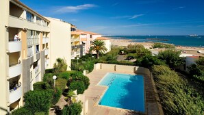 Ein Hotel mit Pool, Balkonen und Blick auf den Strand.
