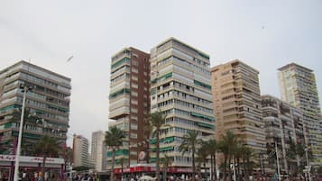 Residents enjoy the vibrant urban atmosphere from their balconies.