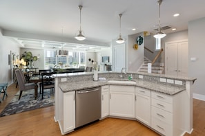 Enjoy cooking in the well-equipped kitchen with a central island, ample counter space, and integrated dishwasher.