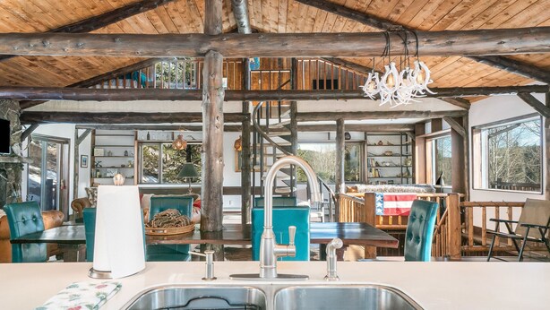 A rustic kitchen with a double sink, wooden beams, and a chandelier. - Luxury Mountain Retreat Near Estes Park Stunning Views, Perfect Family Getaway (Allenspark)