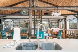 A rustic kitchen with a double sink, wooden beams, and a chandelier. - Luxury Mountain Retreat Near Estes Park Stunning Views, Perfect Family Getaway (Allenspark)