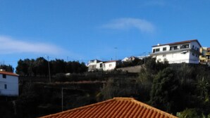 A silver car parked in front of a building with a red-tiled roof. - Atlantic view with free car and bike.  (Gaula)