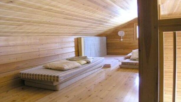 A wooden interior with a bunk bed, a small table, and a window. - Herkkola by Interhome (Taivalkoski)