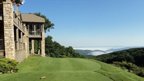 A golf course with a stone building on the left, a well-maintained green, and a view of rolling hills in the distance. - Relax at the Read Retreat-ready to host families all 4 seasons (Beech Mountain)