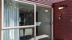 A sliding glass door with a sign reading "12 Just the 3".