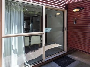 A sliding glass door with a sign reading "12 Just the 3".