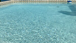 A clear, shallow pool with a tiled edge and a view of the ocean. - BEACH HOUSE W/ POOL (vieques)