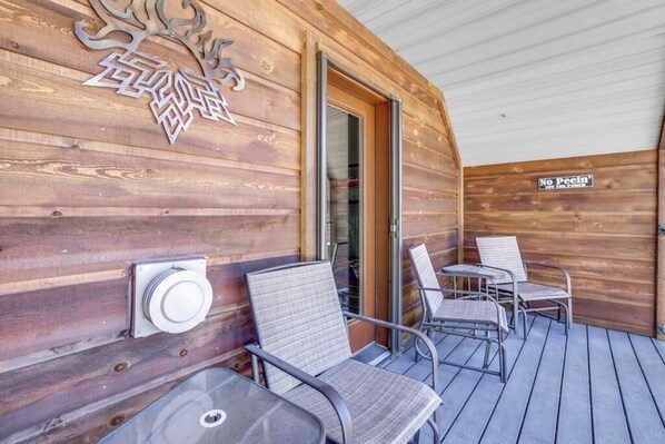 A wooden exterior with a metal railing, a glass door, and a sign that reads "No Peein' Here." - River front cabin surrounded by national forest with outdoor living space (Fairfield)