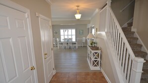 A hallway leading to a dining area with a staircase. - Less than 2 miles to the beach and boardwalk! (Rehoboth Beach)