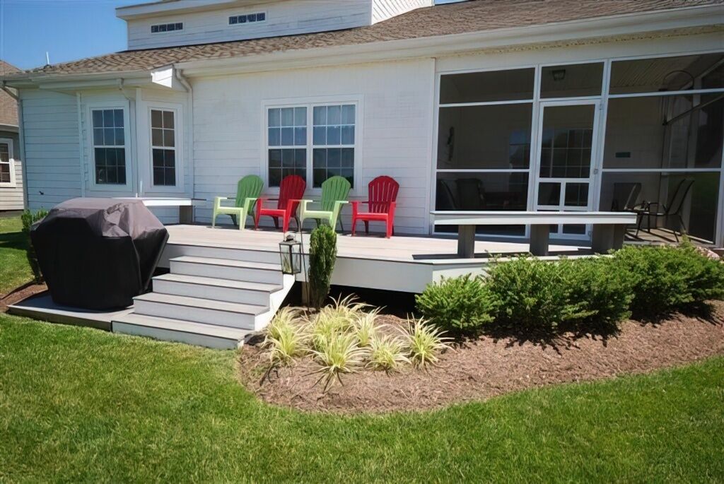 A house with a covered patio, outdoor seating, and a well-maintained garden.