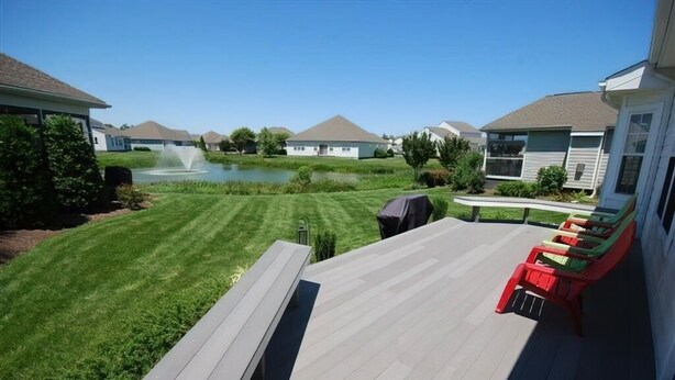 A deck with a lawn and a pond, surrounded by houses. - Less than 2 miles to the beach and boardwalk! (Rehoboth Beach)