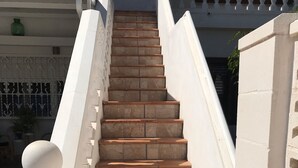 A staircase with stone steps and white railings.