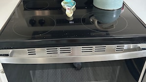 A stainless steel oven with a digital control panel, a kettle, and a bottle of Weiman Cook Top Creamer. - Close enough to the beach but far enough from all of the noise! No pet fee! (Myrtle Beach,)