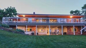 A two-story house with a covered patio and a balcony. - No Cleaning Fee! Luxury Broadmoor Home w/ Hot Tub & Fire Pit (Broadmoor)
