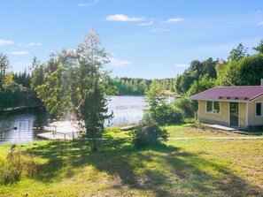 A lakeside property with a house, dock, and surrounding greenery. - Villa kaisla by Interhome (Juva)