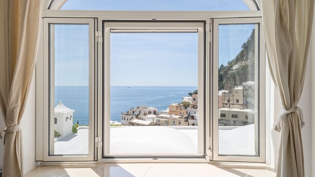 A room with a large arched window overlooking a coastal town and the sea. - Positano Center - Guest 4+2 People in 2 Bedrooms, 2 Bathrooms - AC and WiFi free (Positano)